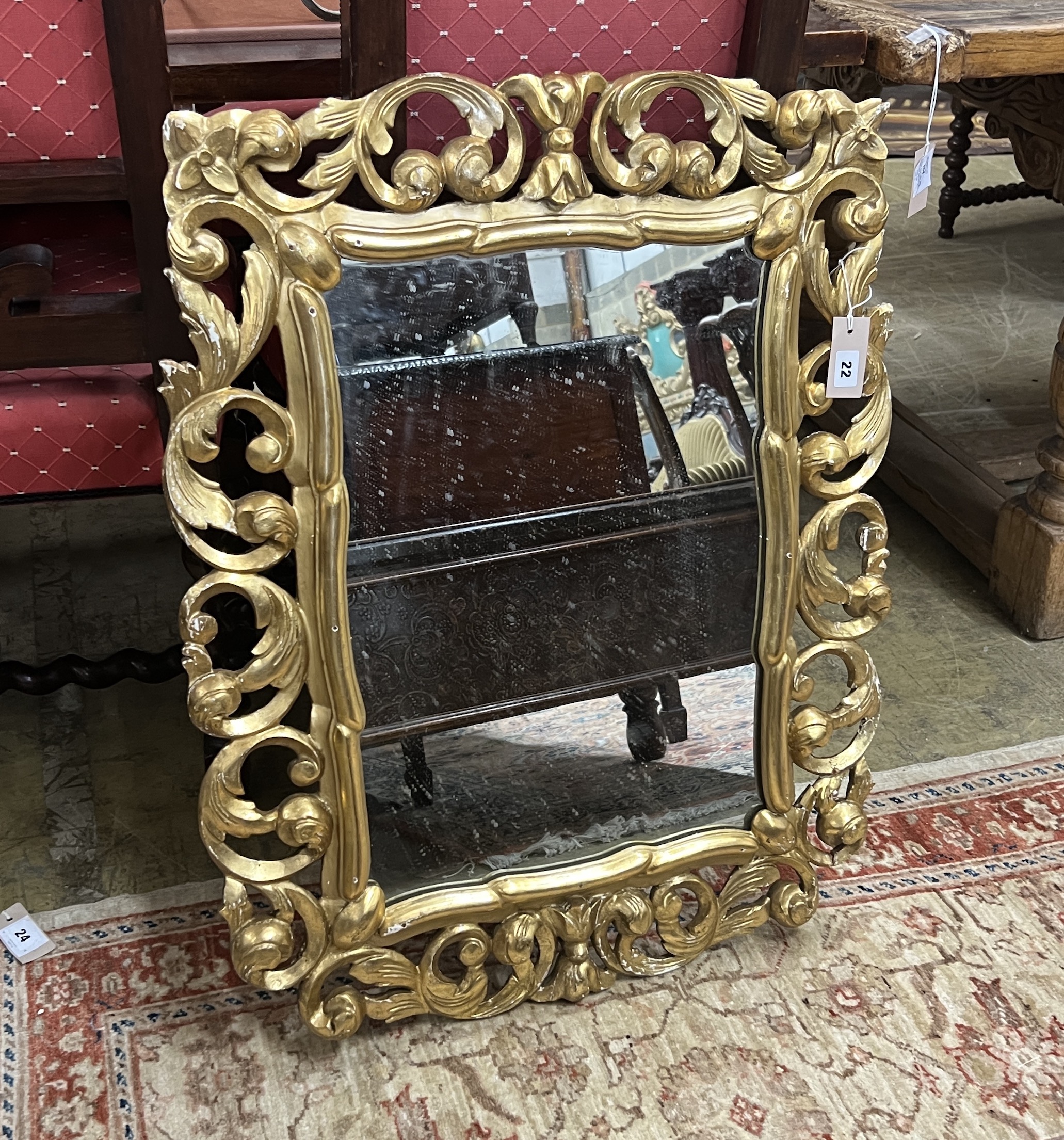 A rectangular Florentine style carved giltwood wall mirror, width 65cm, height 81cm